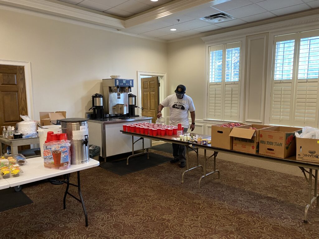 Howard, the director of Our Daily Bread Community Kitchen, sets out water before the kitchen opens for lunch.